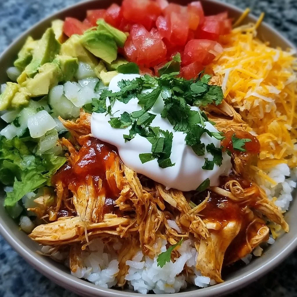 Slow Cooker Chicken Burrito Bowl topped with fresh ingredients